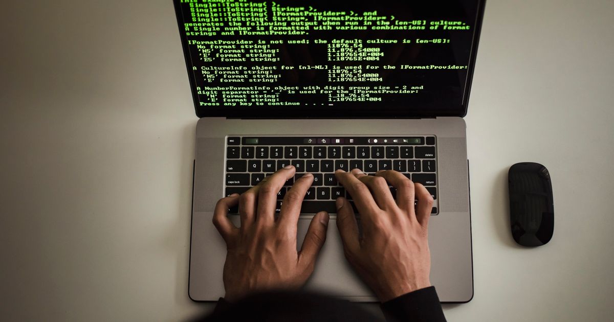 Person browsing and researching on a laptop in a modern workspace