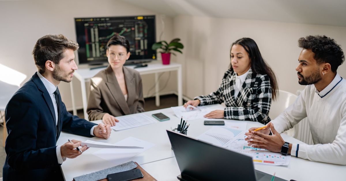 Diverse marketing team meeting around a conference table to plan a digital PR campaign