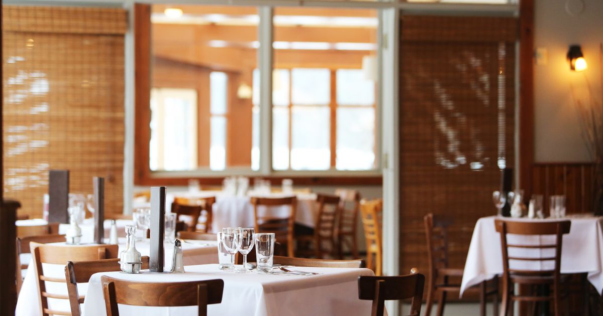 Busy restaurant dining room full of customers during service