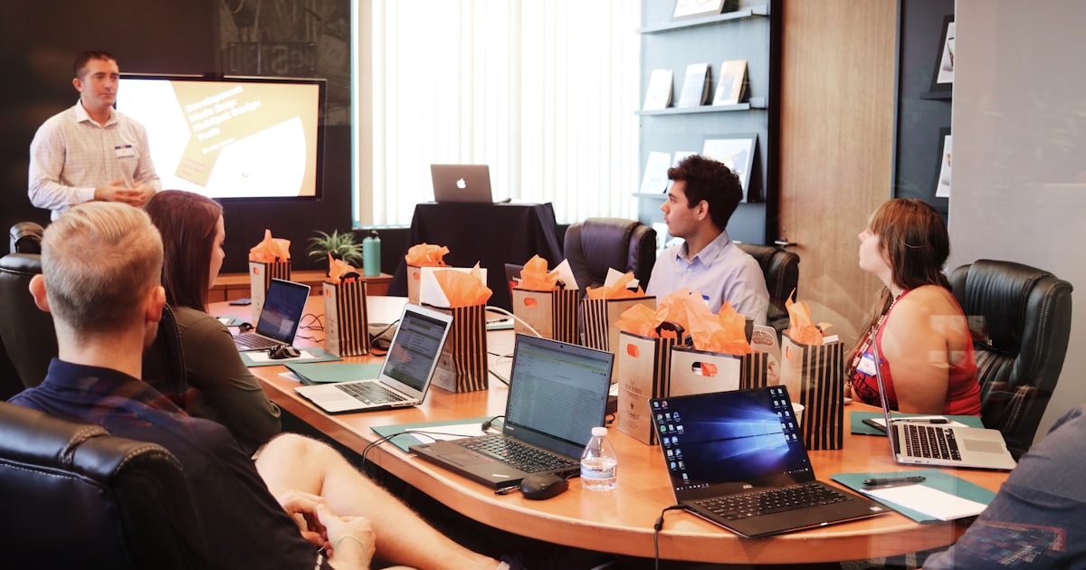 Business team discussing SaaS growth strategy around a conference table
